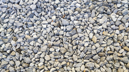 Gravel road stone texture. Gray gravel pattern. Closeup road with small rocks background