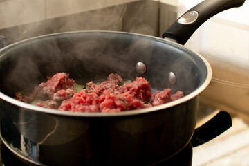 Cooking Raw Ground Beef with Vegetables in a Pan