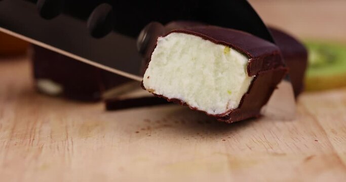 cut sweet green cottage cheese with kiwi flavor in chocolate glaze, delicious dessert cottage cheese in chocolate