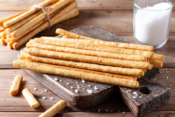 Traditional italian breadsticks grissini with salt on table