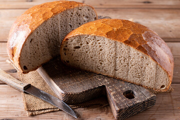 Fresh bread on wooden ground. Freshly baked traditional bread on table. Healthy food