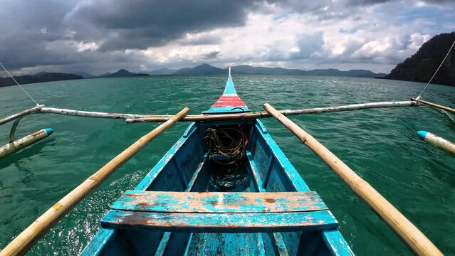 Philippine Sea - Fisherman Catamaran Boat Fast Gliding Towards Rocky Islands - Cloudy Day