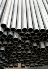 Stack of steel pipes. Close - up of stack of metal pipes. Industrial elements closeup. Parts...