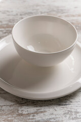 empty white plate on white wooden table