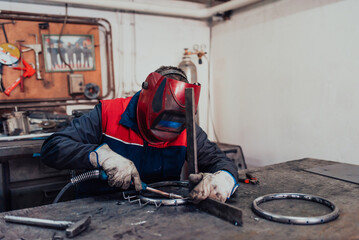 Welder erecting technical steel. Industrial steel welder in factory technical