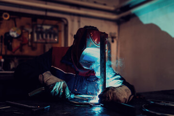 Welder erecting technical steel. Industrial steel welder in factory technical