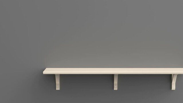 Empty wooden shelf on a grey wall