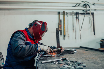 Welder erecting technical steel. Industrial steel welder in factory technical