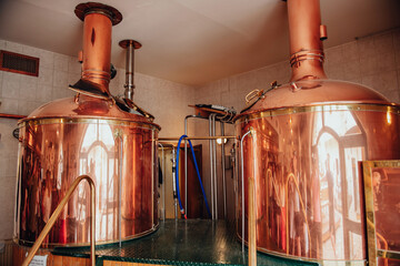 brewery, copper vats with beer. View of beer brewery interior with traditional fermenting copper vats. Modern brewery. Craft beer production line. Copper tanks for brewing