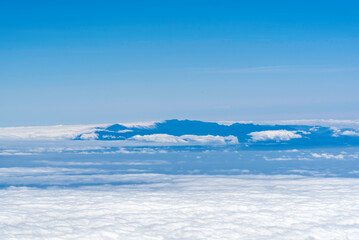 View from above the clouds on mountains far away