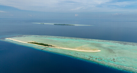 Aerial view of tropical island on the atoll and coral reef. Timba Timba islet. Tun Sakaran Marine Park. Borneo, Sabah, Malaysia.