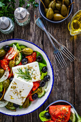 Fresh vegetable salad with feta cheese on wooden table
 - obrazy, fototapety, plakaty