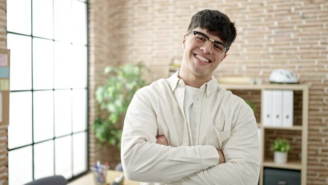 Young hispanic man business worker smiling confident at office