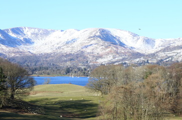 English Lake District National Park with Windermere and the snow covered Cumbrian Mountains on a bright, cloudless winters day.