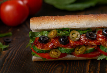 sandwich with olives and tomato, close up