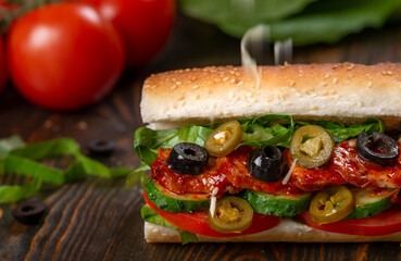 sandwich with olives and tomato, close up