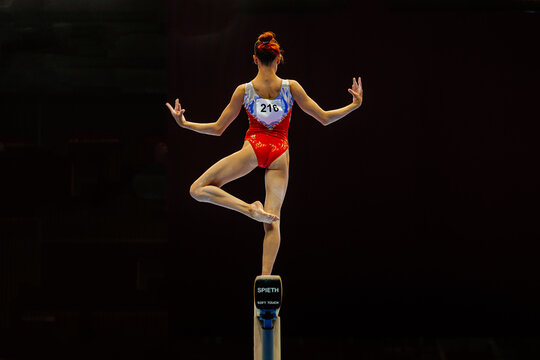 back female gymnast performing exercise balance beam on black background, Spieth balance beam model Soft touch, summer sports games