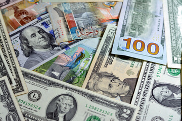 Background of American USA dollars cash money banknotes of different values and Kuwait dinars...