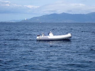 small inflatable motorboat on the open sea.