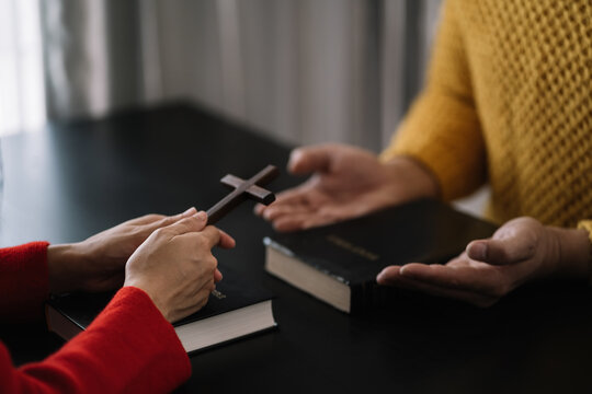 Asian men and women hands praying to god with the bible. Pray for god blessing. Religious beliefs Christian life crisis prayer to god.