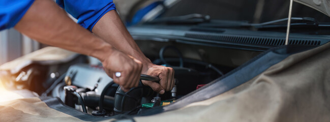 Close up technician uses multimeter voltmeter to check voltage level in car battery. Service and Maintenance car battery.