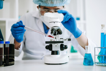 Male scientist researcher conducting an experiment in laboratory..