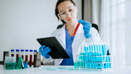 Female scientist researcher conducting an experiment working in the laboratory