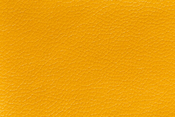 Naklejka premium Yellow leather and a textured background.