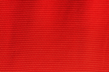 Red color sports clothing fabric football shirt jersey texture and textile background.