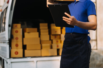 Asian business men use laptop computer checking customer order online shipping boxes at home. Starting Small business entrepreneur SME freelance