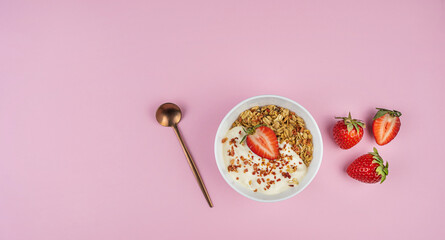 Healthy food concept: homemade granola with yogurt and strawberries. Oatmeal with freeze-dried...