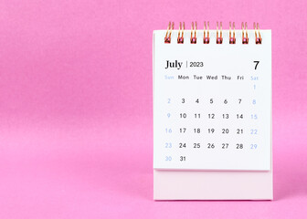 Obraz na płótnie Canvas The July 2023 desk calendar on pink color background.