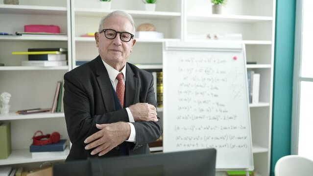 senior teaching standing by white board at university classroom