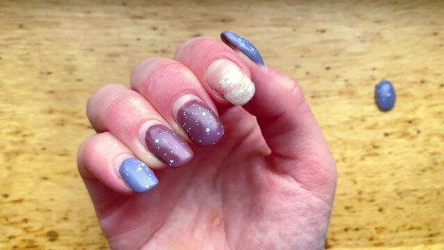 Close-up damaged ruined female gray brown shellac weak thin regrown nails,consequences of gel polish.Home manicure concept.Fashion salon beauty,Glitter nail womens polish scratches spoiled,4k footage