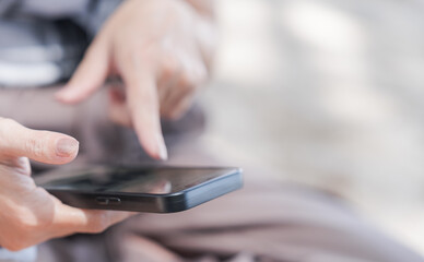 Women hand holding smartphone and finger touching on monitor for communication social online business