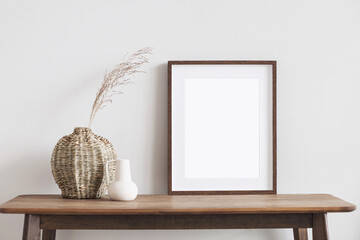 Blank wooden picture frame mockup on wall in modern interior. Vertical artwork template mock up for...