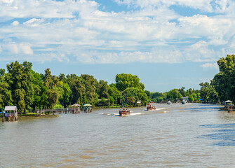 Mahogany boats ferry passengers from the port to their homes and landing stages on Parana delta in...