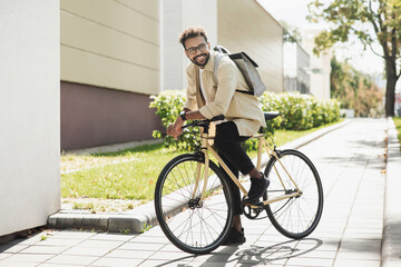 Young handsome man with bike in a city, Smiling student man with bicycle smiling outdoor, Modern healthy lifestyle, travel, casual business concept