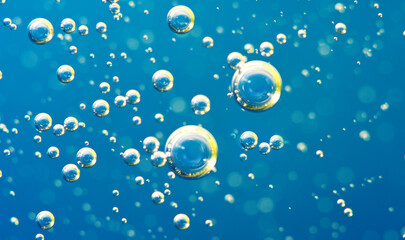 Underwater background of clear blue water with oxygen bubbles closeup