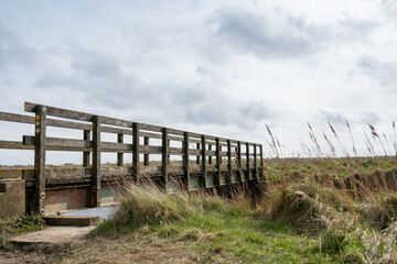 Fototapeta premium Bridge over the river on the Suffolk Coast Path