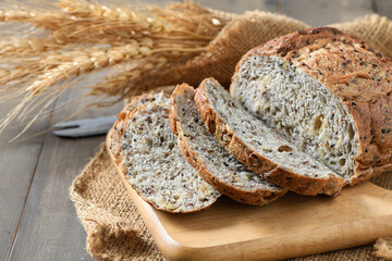 Sliced Multi grain sourdough on wood plate with Barley rice, home made bakery