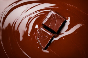 Chocolate day 2023 with melting chocolate bar with creamy background