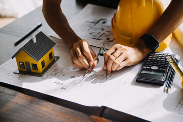 Construction and structure concept of Engineer or architect meeting for project working with partner and engineering tools on model building and blueprint in working site, contract for both companies.