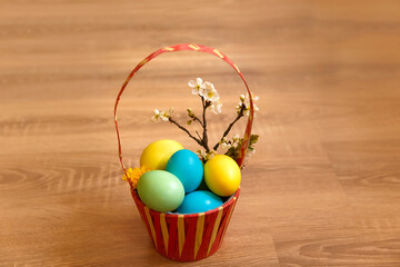 Paint eggs for Easter, bright Easter holiday, children paint eggs, colored eggs in a basket, colored eggs on a stand, Holiday background 