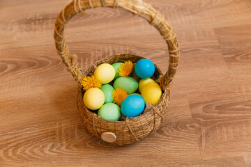 Paint eggs for Easter, bright Easter holiday, children paint eggs, colored eggs in a basket, colored eggs on a stand, Holiday background 