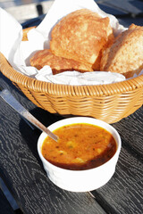 Indian cuisine - Puri Bhaji. It is a traditional breakfast dish in North India. Puri is a deep fried bread made from whole wheat flour and Served with spicy Potato curry called bhaji or alu ki sabji.