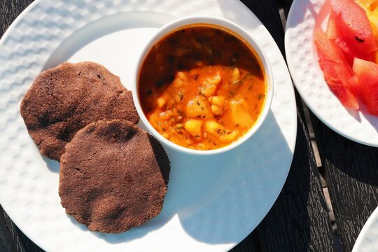 Indian fasting breakfast or lunch thali. Aloo ki sabzi or potato curry along with Sabudana Vada and Kuttu ki puri. Fried buckwheat bread. Served with fresh fruits. Copy space. Navratri, Mahashivratri 