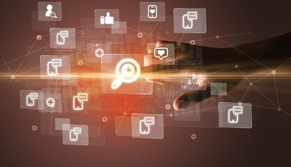 Hand pressing social media multimedia application screen with media icons on futuristic concept