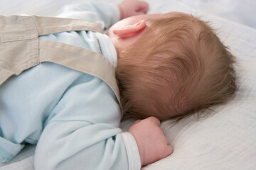 Obraz na płótnie Canvas Baby sleeping on his belly close up