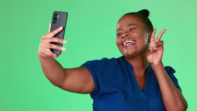 Selfie of black woman isolated on studio background or green screen with social media kiss, peace sign and emoji. Face of happy model or person in profile picture update or influencer lifestyle post